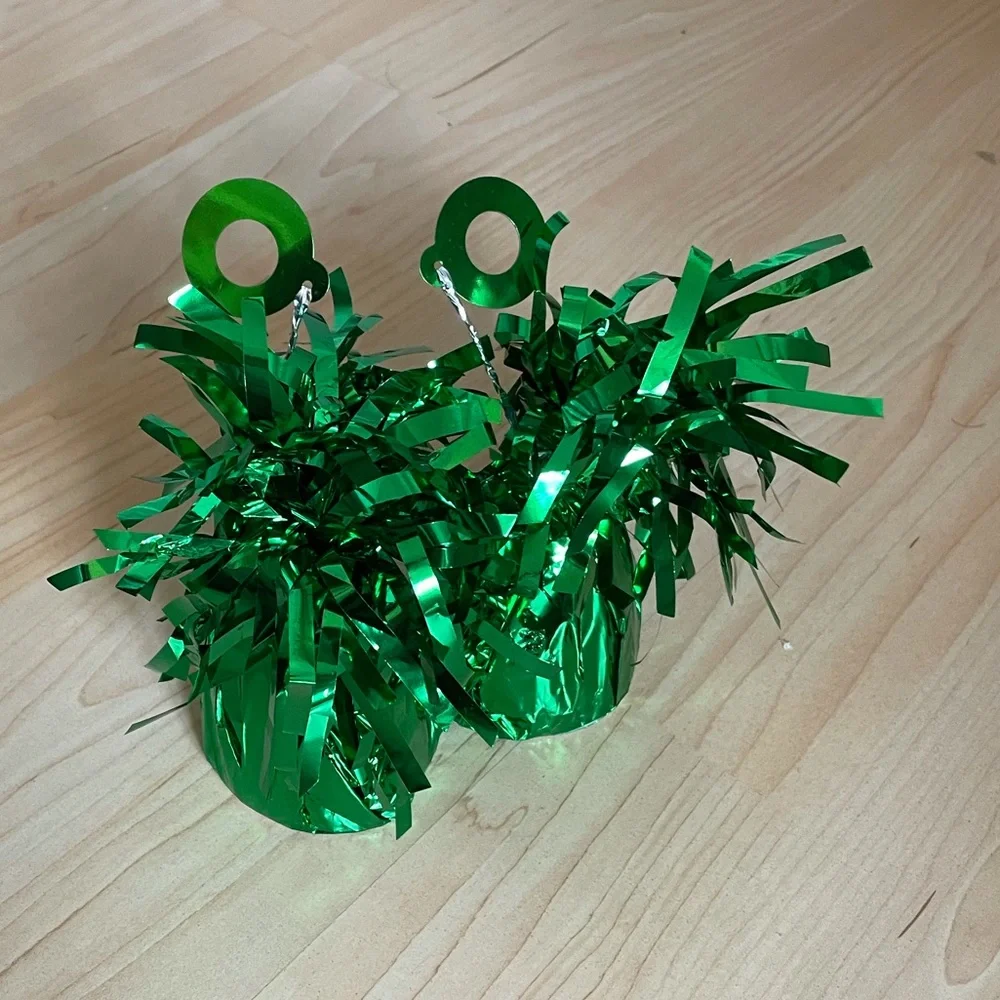 Two balloon weights in green metallic